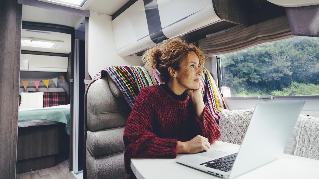 Adult woman using laptop in the campground