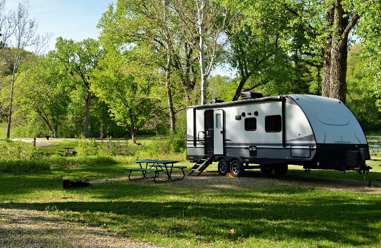 Travel trailer camping in the woods