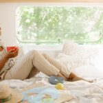 Young woman relax in bed, camping in a trailer