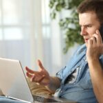 irritated man talking on the phone