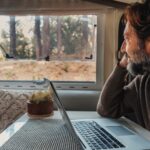 mature man working on laptop in rv park