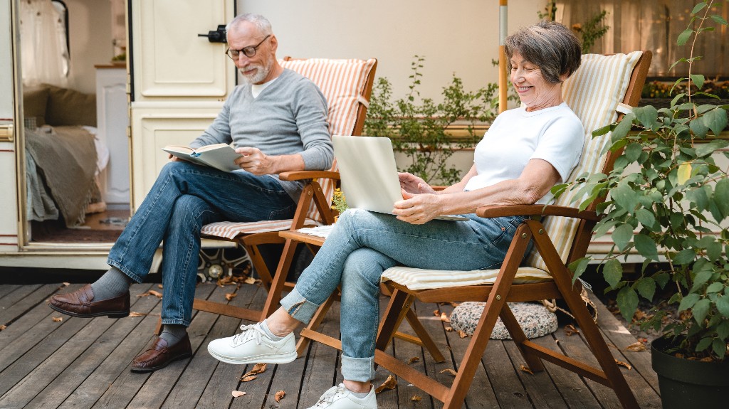 Adult couple is using laptop in RV Park